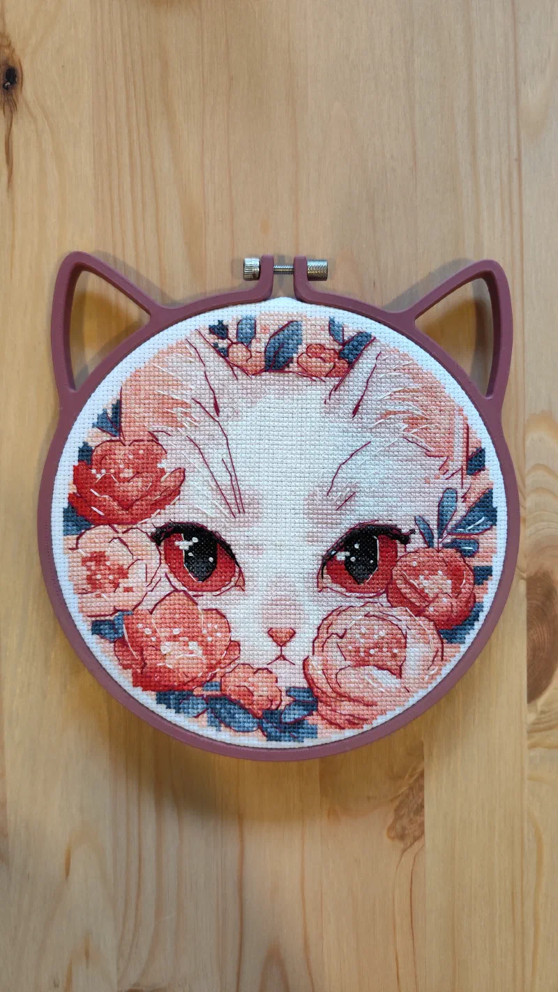 Cat pattern framed in a 3D printed cat style embroidery hoop.