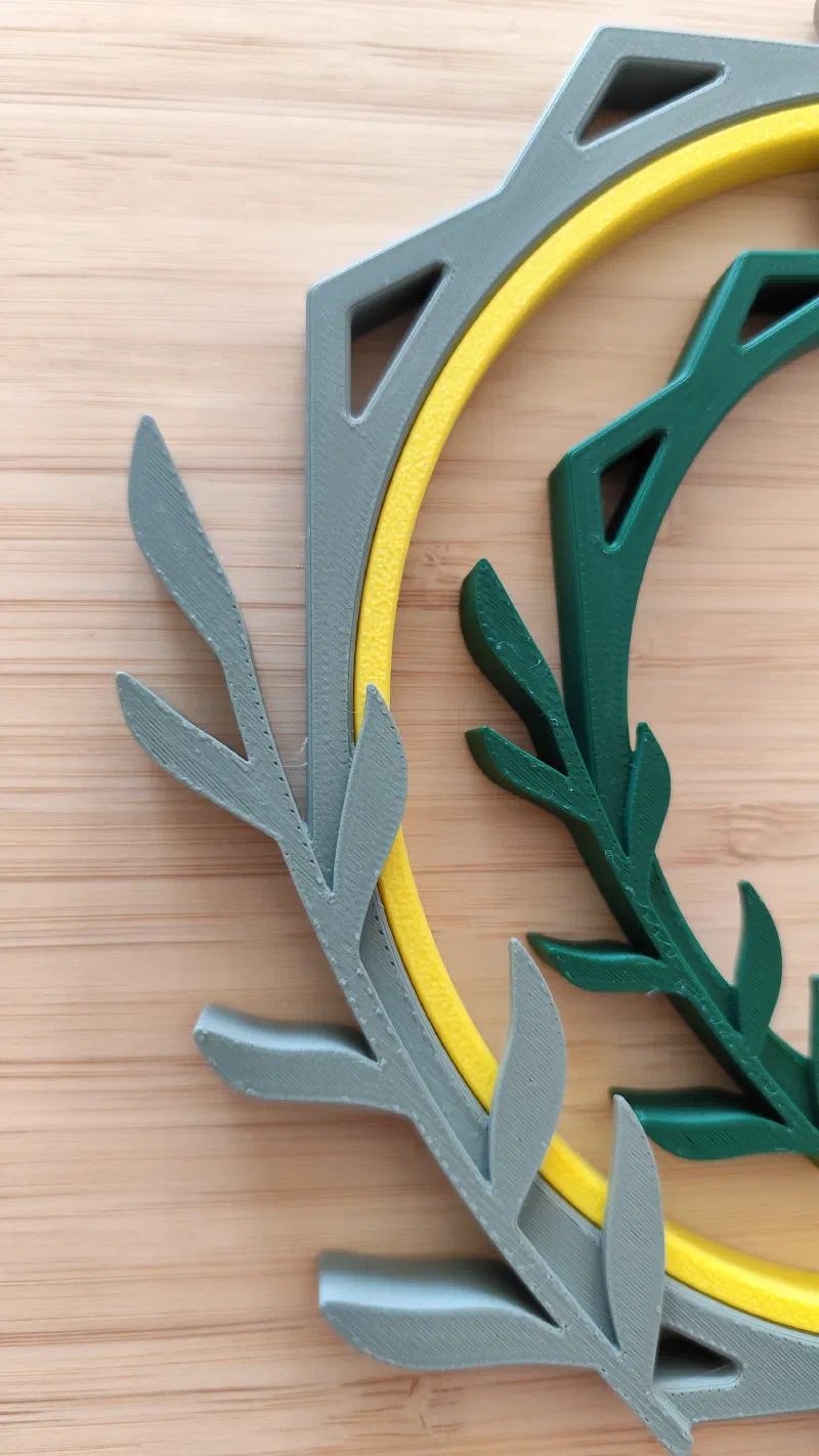 Close-up of a geometric 3D printed embroidery hoop with leaves.