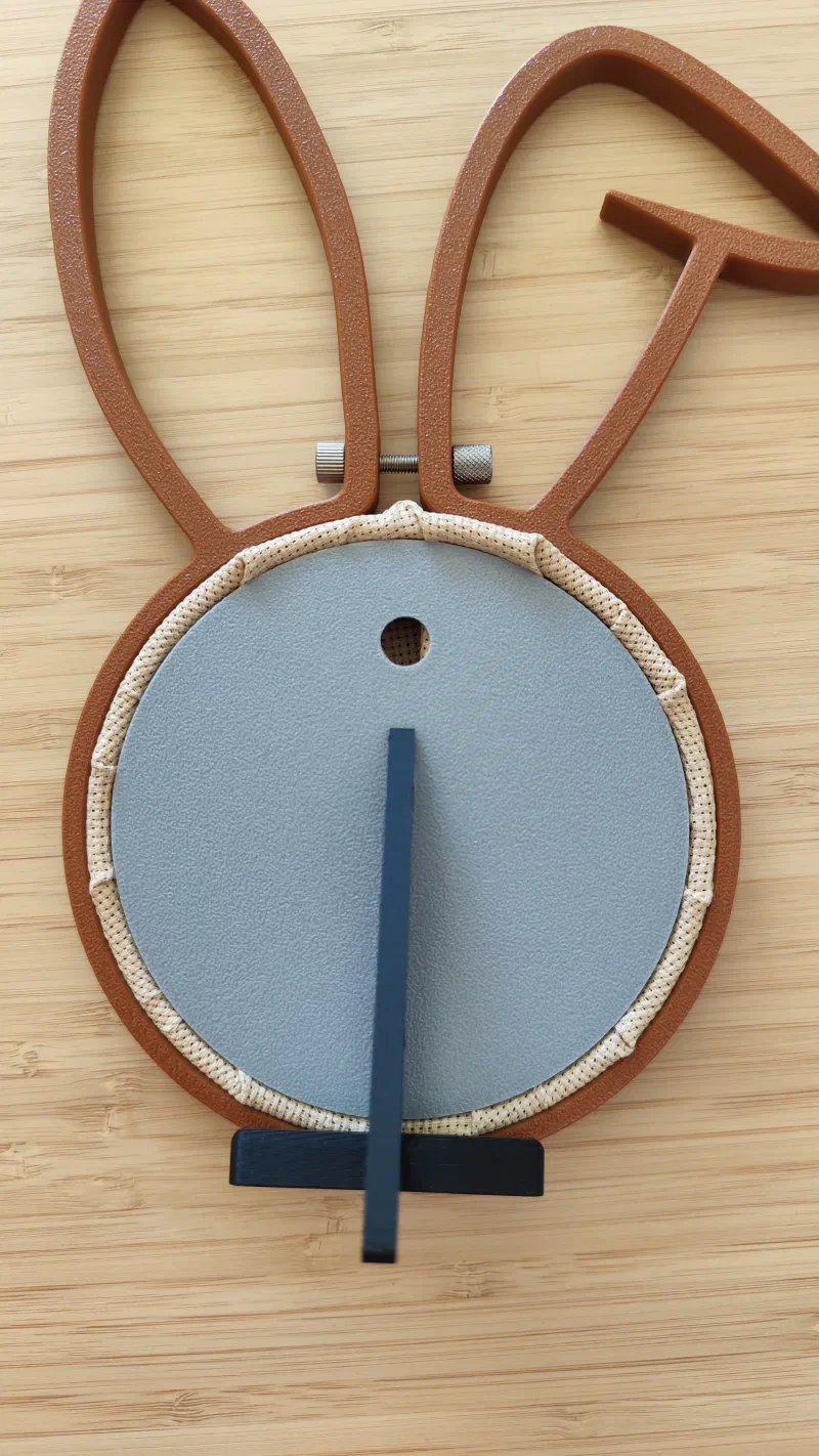 Backside of a 3D printed bunny embroidery hoop showing the custom cover and stand.